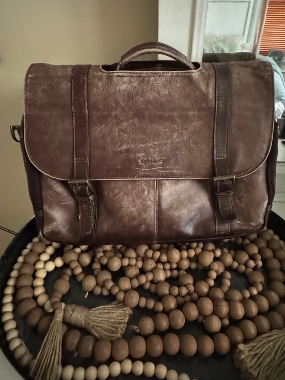 Samsonite brown leather flapover messenger bag with dual buckle straps